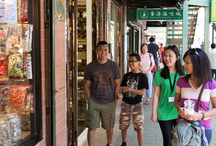 A group of travelers admires storefronts in the Chinatown neighborhood on a Chicago Greeter visit.