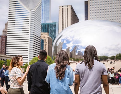 A group of visitors at The Bean in Chicago’s Millennium Park.